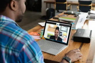 African IT team working at computers in a modern office